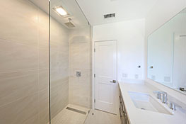 Bathroom with Floor to Ceiling Porcelain Tile and Walk-in Rain Shower